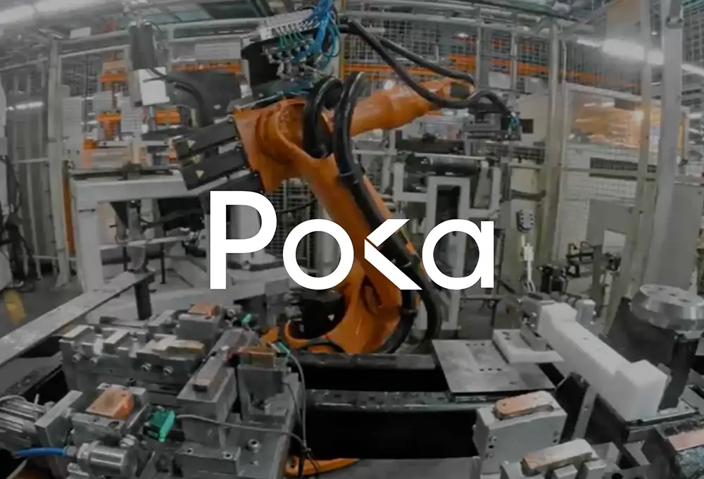 Factory robot machinery with Poka logo displayed.