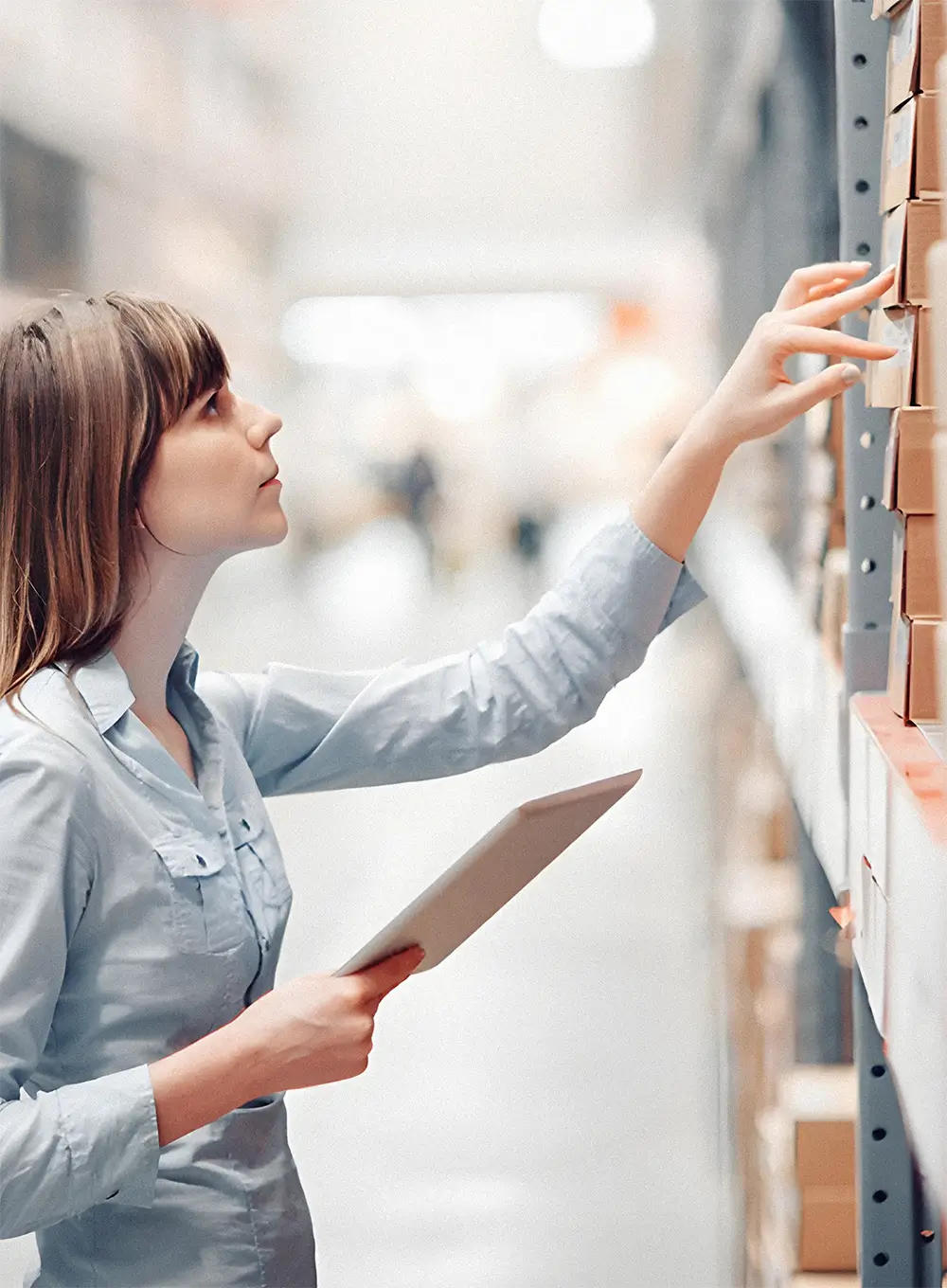 Woman checking inventory in a warehouse.