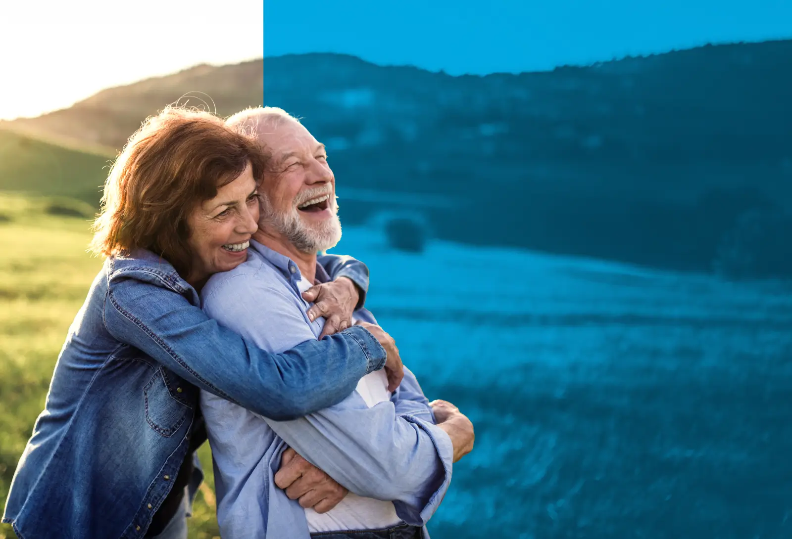 Smiling senior couple embracing outdoors in a scenic countryside setting during golden hour.