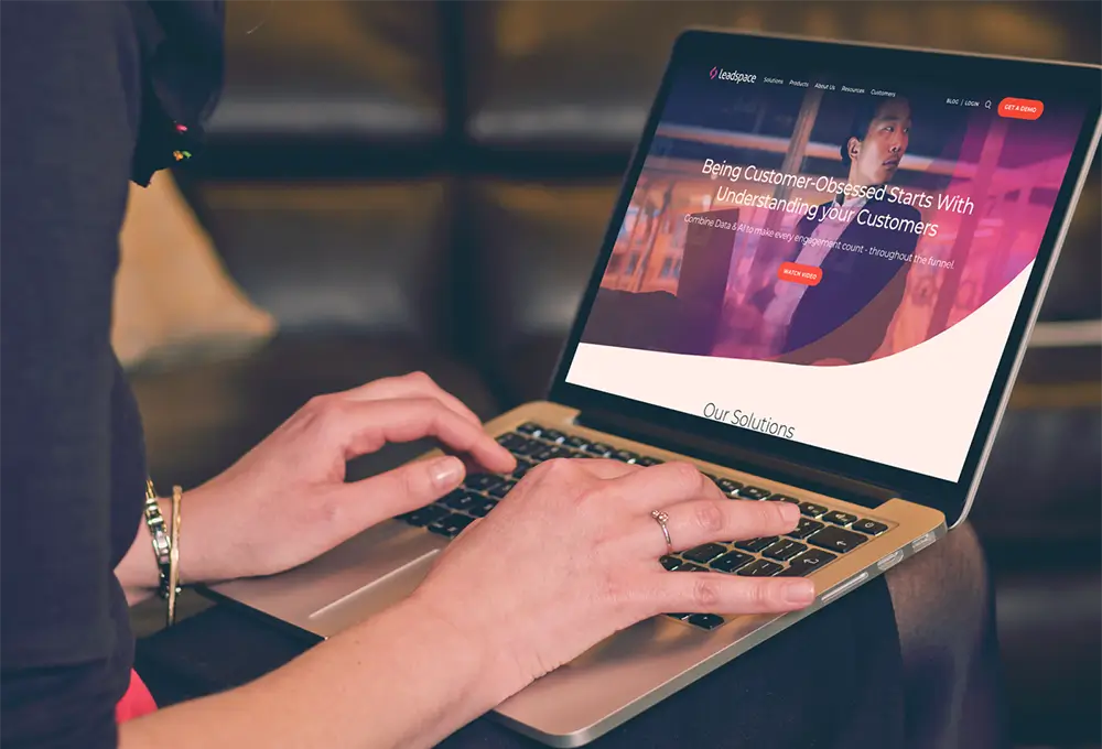 Person using a laptop displaying the Leadspace website and customer engagement platform.