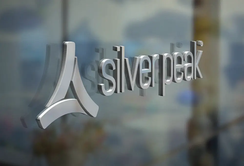 Close-up of the Silver Peak logo displayed on a glass office wall.
